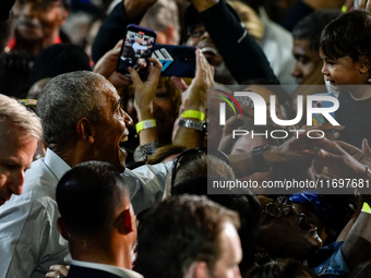 Former President Barack Obama shakes the hands of attendees at the conclusion of a presidential campaign rally for Kamala Harris at The Hunt...