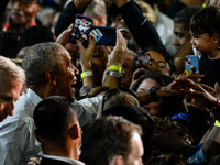 Former President Barack Obama shakes the hands of attendees at the conclusion of a presidential campaign rally for Kamala Harris at The Hunt...