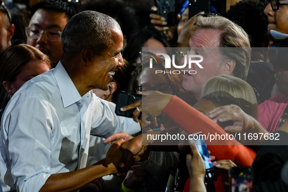 Former President Barack Obama shakes the hands of attendees at the conclusion of a presidential campaign rally for Kamala Harris at The Hunt...