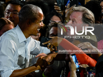 Former President Barack Obama shakes the hands of attendees at the conclusion of a presidential campaign rally for Kamala Harris at The Hunt...