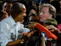 Former President Barack Obama shakes the hands of attendees at the conclusion of a presidential campaign rally for Kamala Harris at The Hunt...