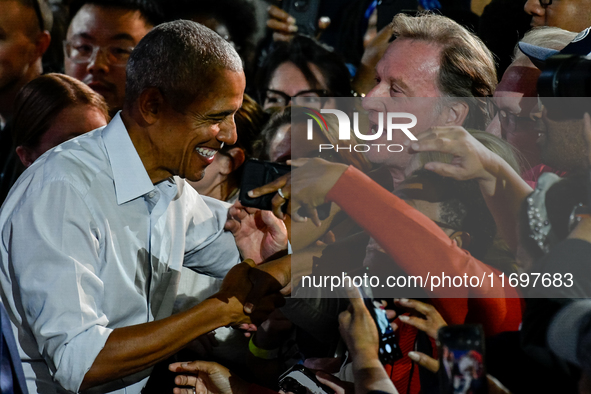 Former President Barack Obama shakes the hands of attendees at the conclusion of a presidential campaign rally for Kamala Harris at The Hunt...