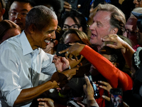 Former President Barack Obama shakes the hands of attendees at the conclusion of a presidential campaign rally for Kamala Harris at The Hunt...