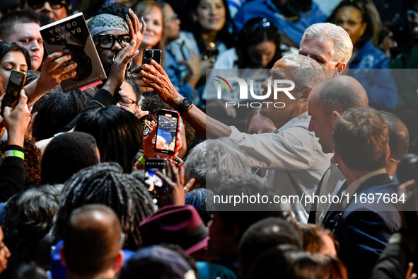 Former President Barack Obama shakes the hands of attendees at the conclusion of a presidential campaign rally for Kamala Harris at The Hunt...