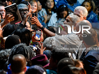 Former President Barack Obama shakes the hands of attendees at the conclusion of a presidential campaign rally for Kamala Harris at The Hunt...