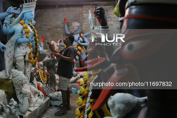 An artisan makes an idol of the Hindu Goddess Kali in Kumartuli, the potter's village in Kolkata, India, on October 22, 2024. 