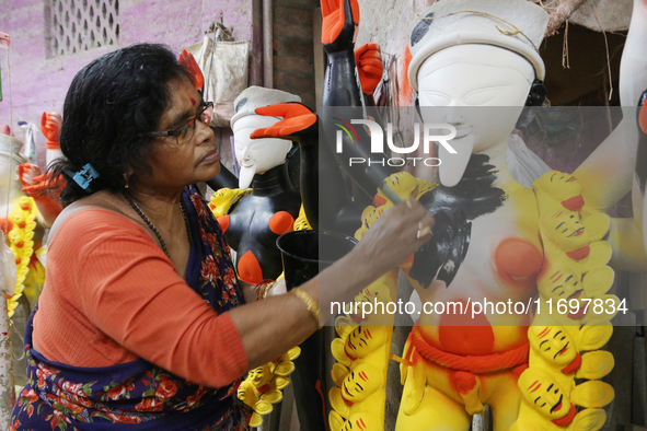 The idol-maker China Pal makes an idol of the Hindu Goddess Kali ahead of the Kali Puja Festival in Kumartuli, the potter's village in Kolka...