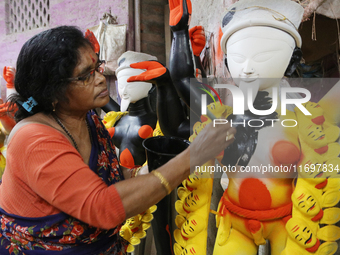 The idol-maker China Pal makes an idol of the Hindu Goddess Kali ahead of the Kali Puja Festival in Kumartuli, the potter's village in Kolka...