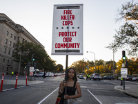 A person holds a sign during the National Day of Protest to Stop Police Brutality in Washington, D.C., United States, on October 22, 2024. P...