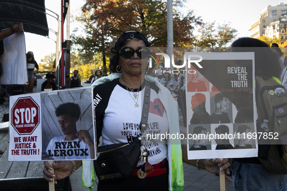 A person holds signs during the National Day of Protest to Stop Police Brutality in Washington, D.C., United States, on October 22, 2024. Pr...