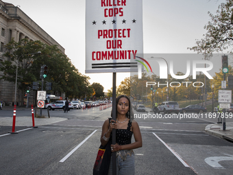 A person holds a sign during the National Day of Protest to Stop Police Brutality in Washington, D.C., United States, on October 22, 2024. P...