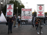 Protesters hold signs during the National Day of Protest to Stop Police Brutality in Washington, D.C., United States, on October 22, 2024. P...