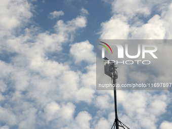 Birds sit on a mobile signal tower as clouds are seen in the sky in Siliguri, India, on October 23, 2024. (