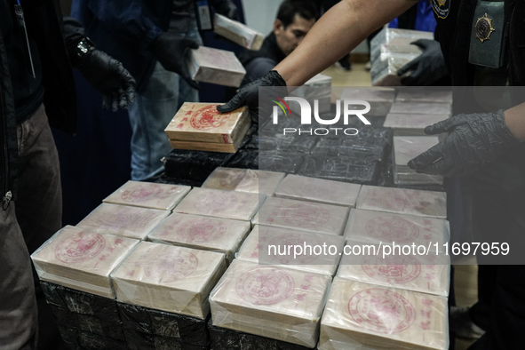 An official of the Narcotics Control Board displays a confiscated 154 kilograms of heroin hidden in their van to be smuggled from Thailand's...