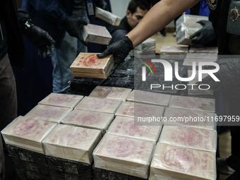 An official of the Narcotics Control Board displays a confiscated 154 kilograms of heroin hidden in their van to be smuggled from Thailand's...