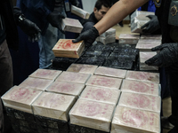 An official of the Narcotics Control Board displays a confiscated 154 kilograms of heroin hidden in their van to be smuggled from Thailand's...