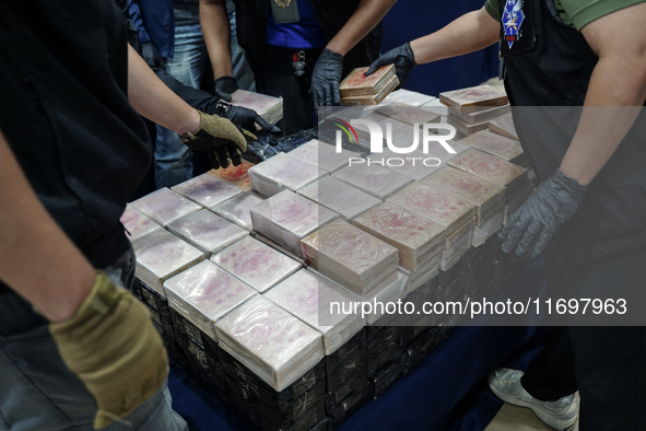 Officials of the Narcotics Control Board collect the seizure of 154 kilograms of heroin hidden in a van to be smuggled from Thailand's centr...