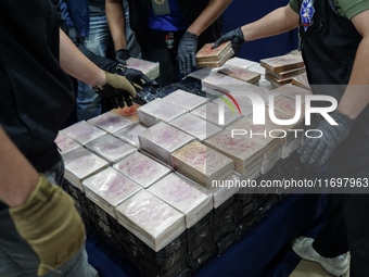 Officials of the Narcotics Control Board collect the seizure of 154 kilograms of heroin hidden in a van to be smuggled from Thailand's centr...