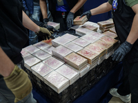 Officials of the Narcotics Control Board collect the seizure of 154 kilograms of heroin hidden in a van to be smuggled from Thailand's centr...