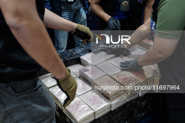 Officials of the Narcotics Control Board collect the seizure of 154 kilograms of heroin hidden in a van to be smuggled from Thailand's centr...