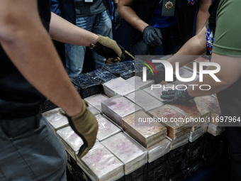 Officials of the Narcotics Control Board collect the seizure of 154 kilograms of heroin hidden in a van to be smuggled from Thailand's centr...