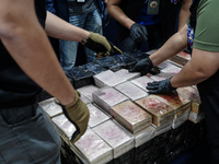 Officials of the Narcotics Control Board collect the seizure of 154 kilograms of heroin hidden in a van to be smuggled from Thailand's centr...