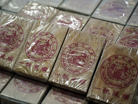 An official of the Narcotics Control Board displays a confiscated 154 kilograms of heroin hidden in their van to be smuggled from Thailand's...