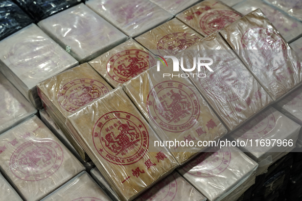 An official of the Narcotics Control Board displays a confiscated 154 kilograms of heroin hidden in their van to be smuggled from Thailand's...