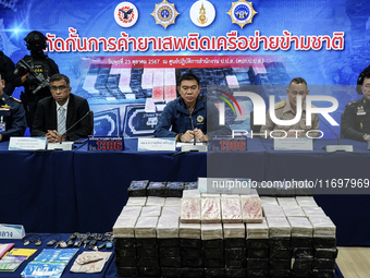 An official of the Narcotics Control Board displays a confiscated 154 kilograms of heroin hidden in their van to be smuggled from Thailand's...