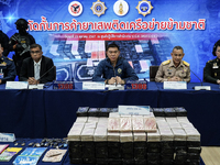 An official of the Narcotics Control Board displays a confiscated 154 kilograms of heroin hidden in their van to be smuggled from Thailand's...