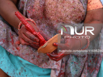 A woman vendor colors earthen lamps 'Diyas' at her roadside shop ahead of the Diwali Festival in Jaipur, Rajasthan, India, on October 23, 20...