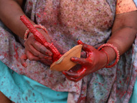 A woman vendor colors earthen lamps 'Diyas' at her roadside shop ahead of the Diwali Festival in Jaipur, Rajasthan, India, on October 23, 20...