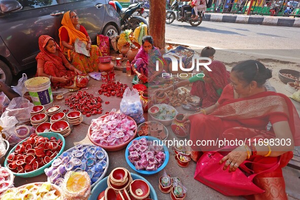 A woman vendor colors earthen lamps 'Diyas' at her roadside shop ahead of the Diwali Festival in Jaipur, Rajasthan, India, on October 23, 20...