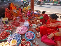 A woman vendor colors earthen lamps 'Diyas' at her roadside shop ahead of the Diwali Festival in Jaipur, Rajasthan, India, on October 23, 20...