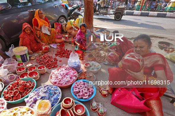 A woman vendor colors earthen lamps 'Diyas' at her roadside shop ahead of the Diwali Festival in Jaipur, Rajasthan, India, on October 23, 20...