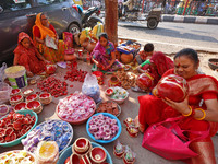 A woman vendor colors earthen lamps 'Diyas' at her roadside shop ahead of the Diwali Festival in Jaipur, Rajasthan, India, on October 23, 20...