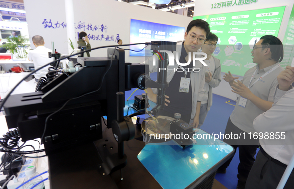 Visitors attend the 14th China International Nanotechnology Industry Expo in Suzhou, China, on October 23, 2024. 