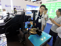 Visitors attend the 14th China International Nanotechnology Industry Expo in Suzhou, China, on October 23, 2024. (