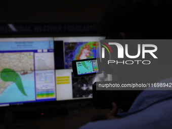 The TV camera's viewfinder screen shows the position of Cyclone Dana inside the Regional Meteorological Centre Kolkata (IMD) office in Kolka...