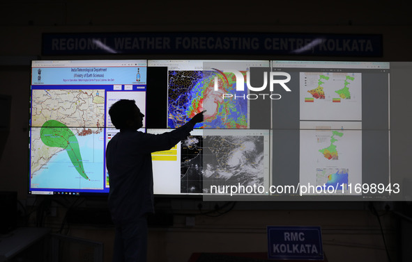 A scientist at the India Meteorological Department Earth System Science Organisation points to a section of the screen showing the position...