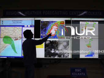 A scientist at the India Meteorological Department Earth System Science Organisation points to a section of the screen showing the position...