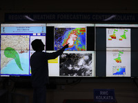 A scientist at the India Meteorological Department Earth System Science Organisation points to a section of the screen showing the position...