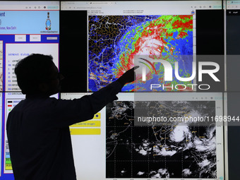 A scientist at the India Meteorological Department Earth System Science Organisation points to a section of the screen showing the position...