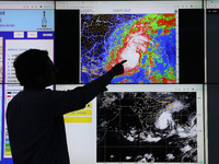 A scientist at the India Meteorological Department Earth System Science Organisation points to a section of the screen showing the position...