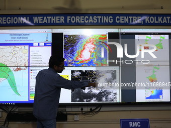 A scientist at the India Meteorological Department Earth System Science Organisation points to a section of the screen showing the position...