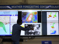 A scientist at the India Meteorological Department Earth System Science Organisation points to a section of the screen showing the position...