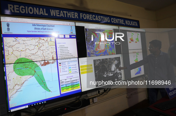 A scientist at the India Meteorological Department Earth System Science Organisation points to a section of the screen showing the position...