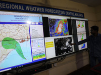 A scientist at the India Meteorological Department Earth System Science Organisation points to a section of the screen showing the position...