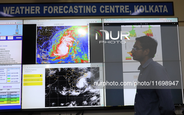 A scientist at the India Meteorological Department Earth System Science Organisation speaks in front of a section of the screen about the po...