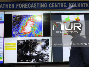 A scientist at the India Meteorological Department Earth System Science Organisation speaks in front of a section of the screen about the po...